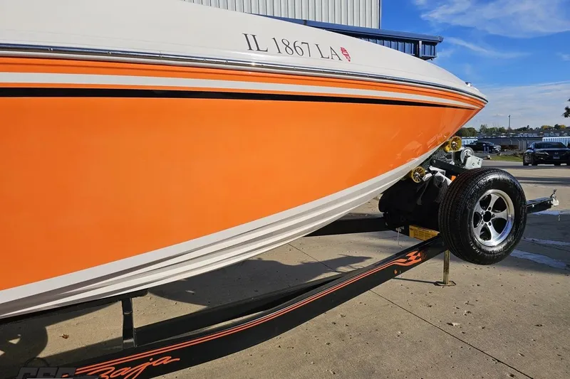 Slide: The Image of 2016 Baja 247 Islander boat with orange hull on trailer, license IL 1867 LA. - 10