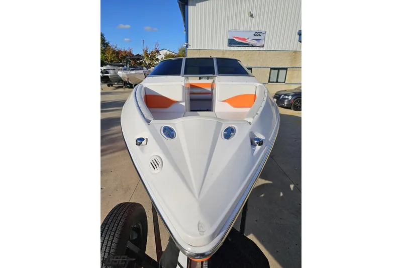 Slide: The Image of 2016 Baja 247 Islander boat with orange seating, parked outdoors on a sunny day. - 14