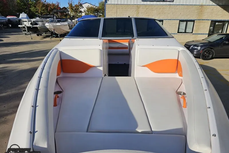 Slide: The Image of 2016 Baja 247 Islander boat with white and orange seating, docked outdoors. - 15