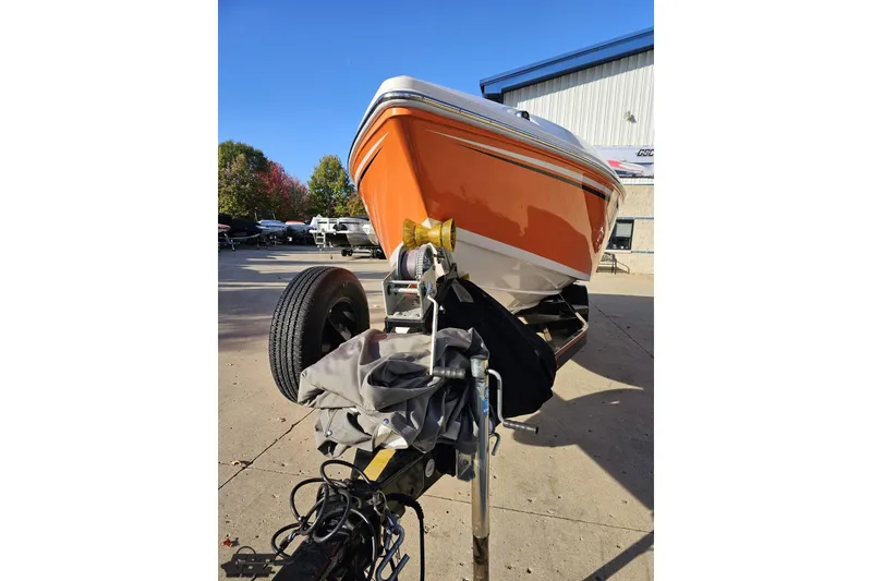 Slide: The Image of 2016 Baja 247 Islander boat on trailer, vibrant orange hull, outdoor setting. - 16