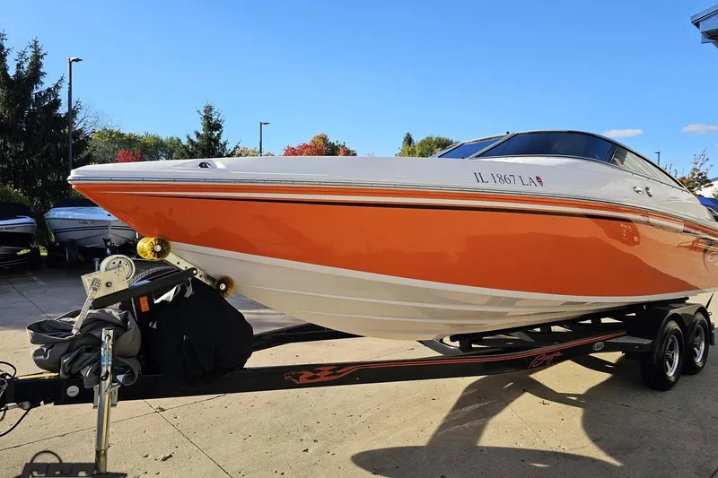 Slide: The Image of 2016 Baja 247 Islander boat with orange hull on a trailer, parked outdoors. - 17