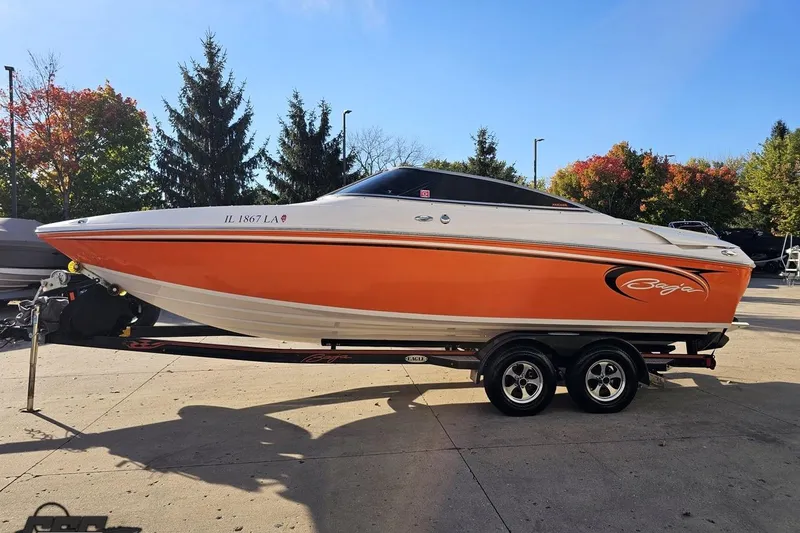 Slide: The Image of 2016 Baja 247 Islander boat with orange and white design on a trailer. - 19