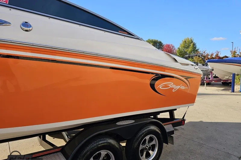 Slide: The Image of 2016 Baja 247 Islander boat with orange and white design on a trailer. - 22