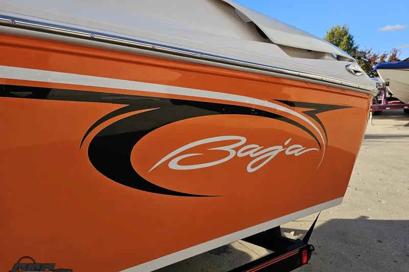 Slide: The Image of Orange 2016 Baja 247 Islander boat with sleek black and white graphics. - 23