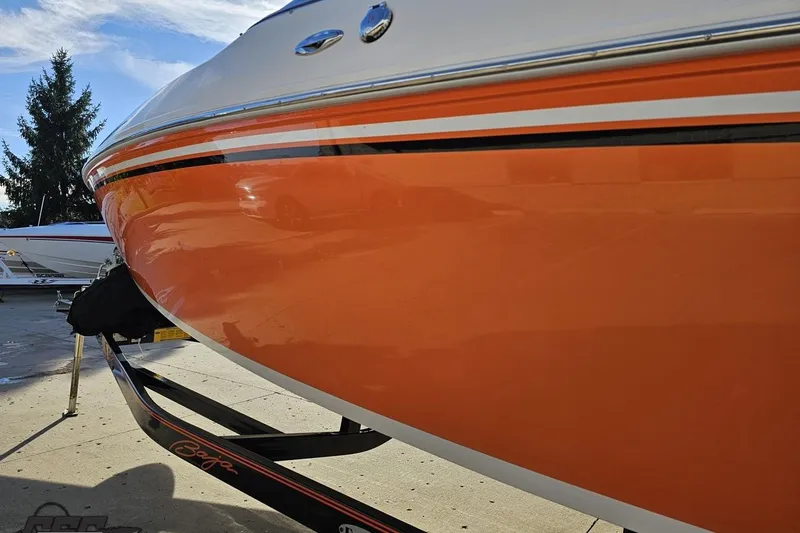 Slide: The Image of 2016 Baja 247 Islander boat with vibrant orange hull on a trailer. - 24