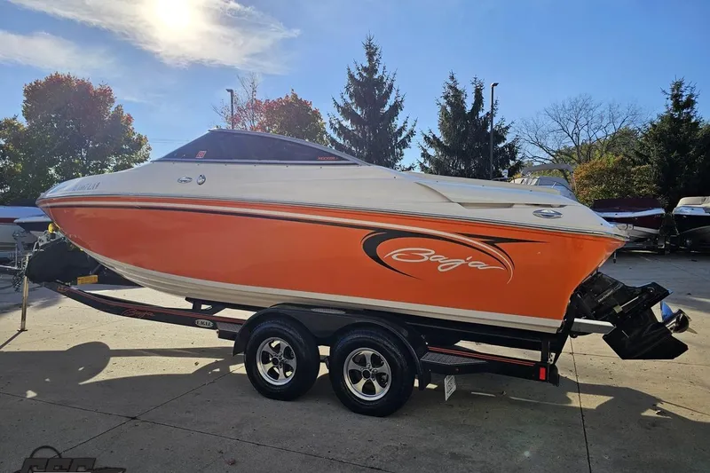 Slide: The Image of 2016 Baja 247 Islander boat with orange and white design on a trailer. - 25