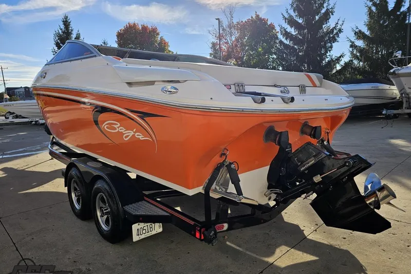Slide: The Image of 2016 Baja 247 Islander boat with orange and white design on a trailer. - 27