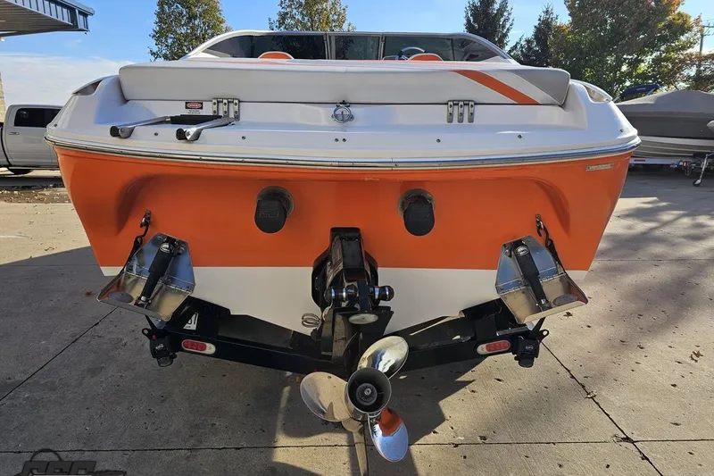 Slide: The Image of 2016 Baja 247 Islander boat, orange and white, rear view with propeller and trim tabs. - 28