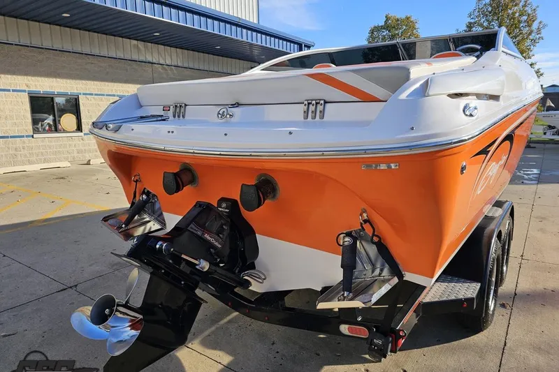 Slide: The Image of 2016 Baja 247 Islander boat with orange and white design, parked on a trailer. - 30