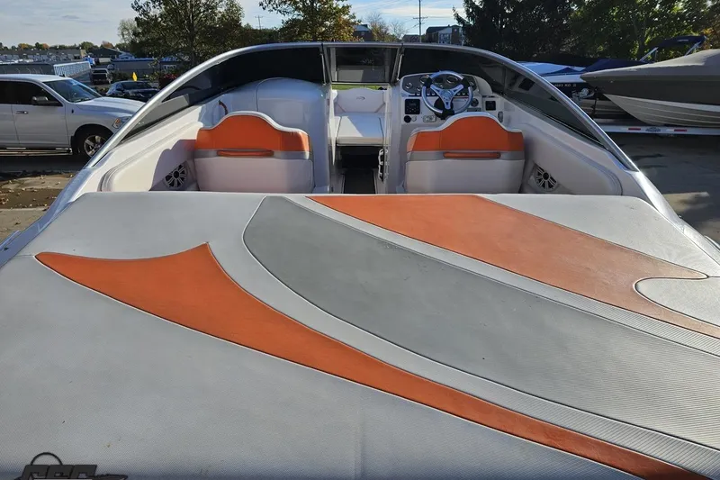 Slide: The Image of 2016 Baja 247 Islander boat with orange and gray interior design, parked outdoors. - 34