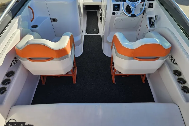 Slide: The Image of 2016 Baja 247 Islander boat interior with orange and white seating, modern dashboard. - 45