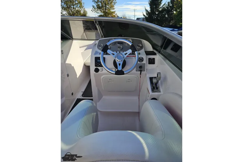 Slide: The Image of 2016 Baja 247 Islander boat cockpit with steering wheel and controls. - 53