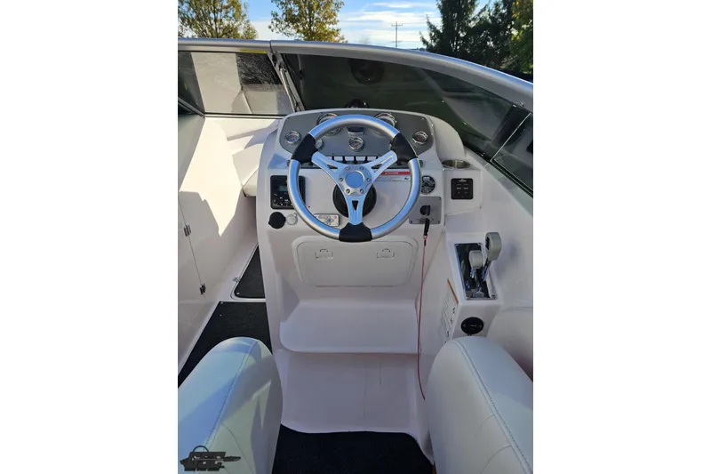 Slide: The Image of 2016 Baja 247 Islander boat cockpit with steering wheel and controls. - 54