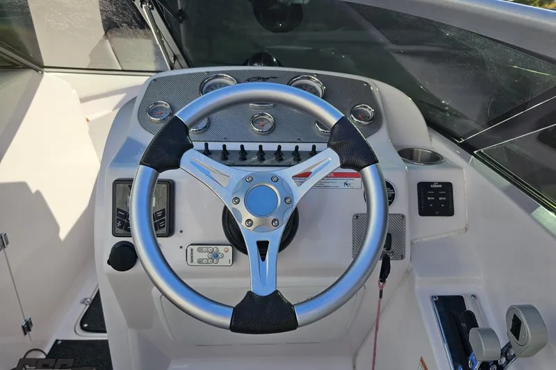 Slide: The Image of Steering wheel and dashboard of 2016 Baja 247 Islander boat cockpit. - 55