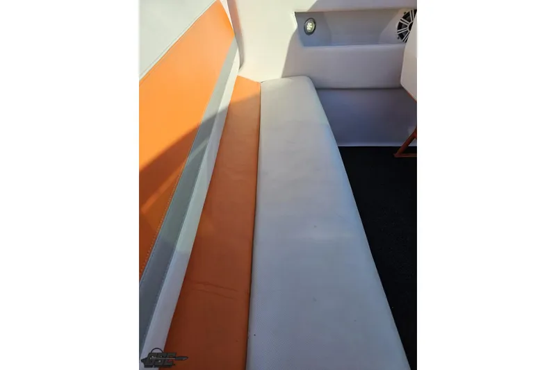 Slide: The Image of Interior seating of 2016 Baja 247 Islander boat with orange and white upholstery. - 56