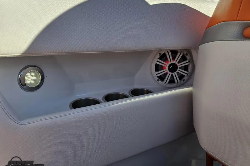 Slide: The Image of 2016 Baja 247 Islander interior with speaker, cup holders, and ambient lighting. - 58