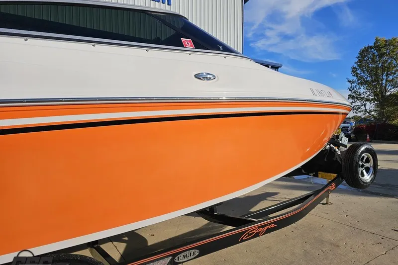 Slide: The Image of 2016 Baja 247 Islander boat with orange and white exterior on a trailer. - 6
