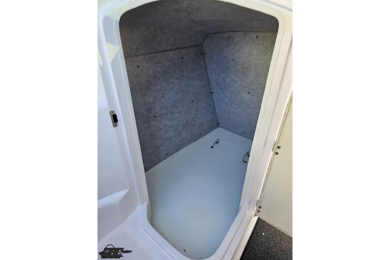 Slide: The Image of Interior cabin of 2016 Baja 247 Islander boat, featuring a compact, carpeted space. - 61