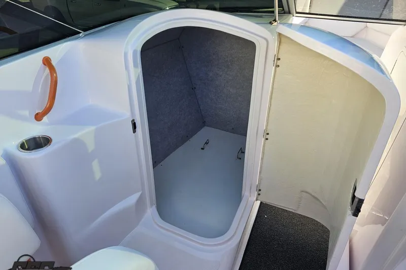 Slide: The Image of 2016 Baja 247 Islander boat interior cabin with open door and cup holder. - 62