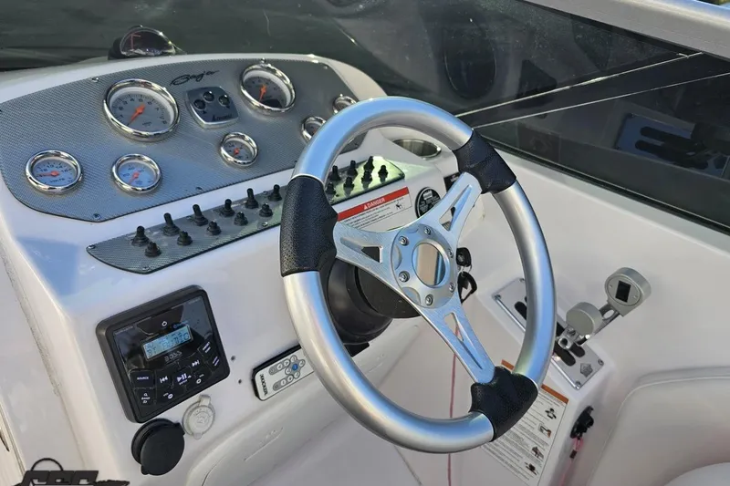 Slide: The Image of Dashboard of a 2016 Baja 247 Islander boat with steering wheel and gauges. - 64