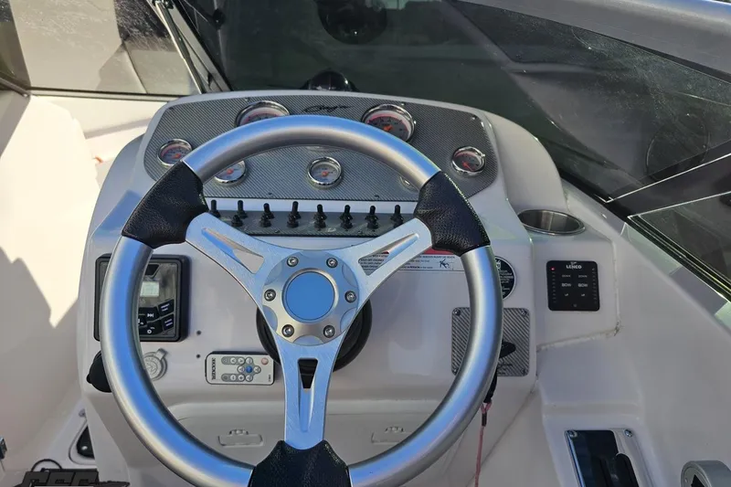 Slide: The Image of Steering wheel and dashboard of a 2016 Baja 247 Islander boat. - 66
