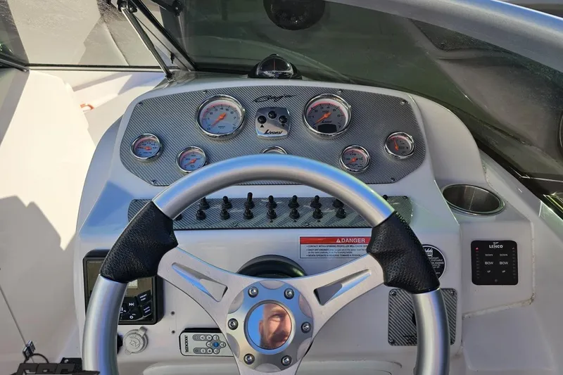 Slide: The Image of 2016 Baja 247 Islander boat dashboard with steering wheel and gauges. - 67
