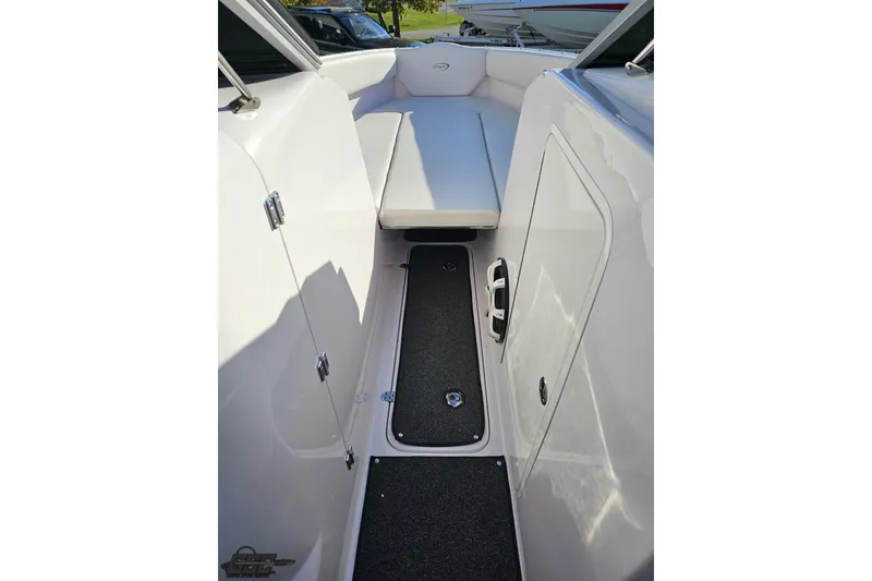 Slide: The Image of 2016 Baja 247 Islander boat interior with white seating and storage compartments. - 69