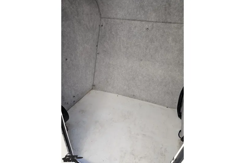 Slide: The Image of Interior cabin of a 2016 Baja 247 Islander boat, featuring a simple, clean design. - 71