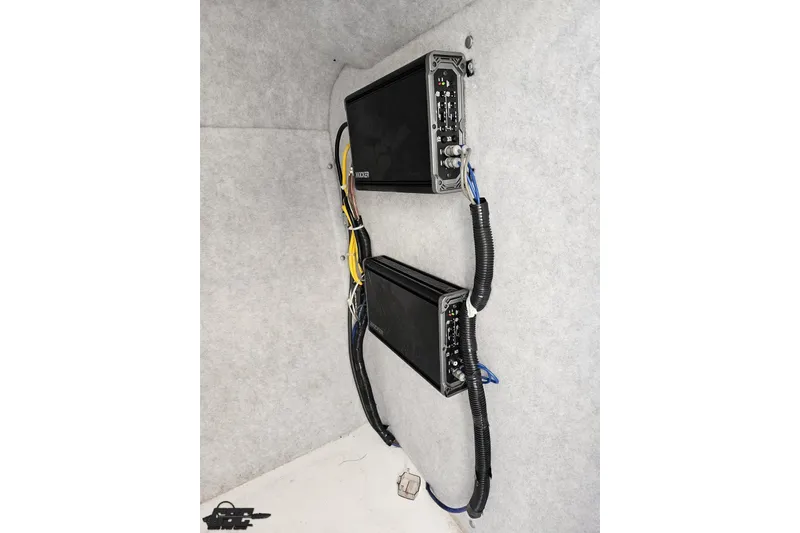 Slide: The Image of Audio amplifiers installed in a 2016 Baja 247 Islander boat, featuring organized wiring. - 72