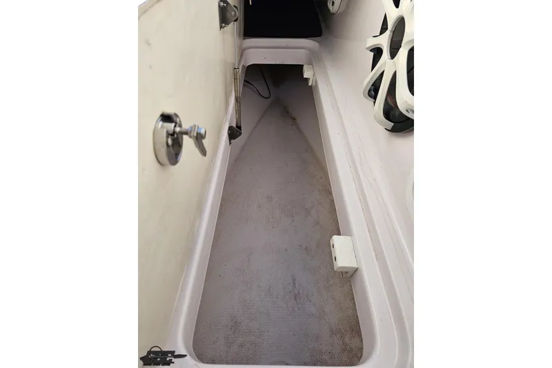 Slide: The Image of 2016 Baja 247 Islander boat interior storage compartment with speakers visible. - 73