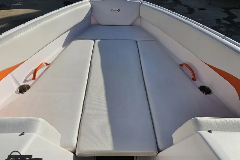 Slide: The Image of 2016 Baja 247 Islander boat interior with white seating and orange accents. - 75