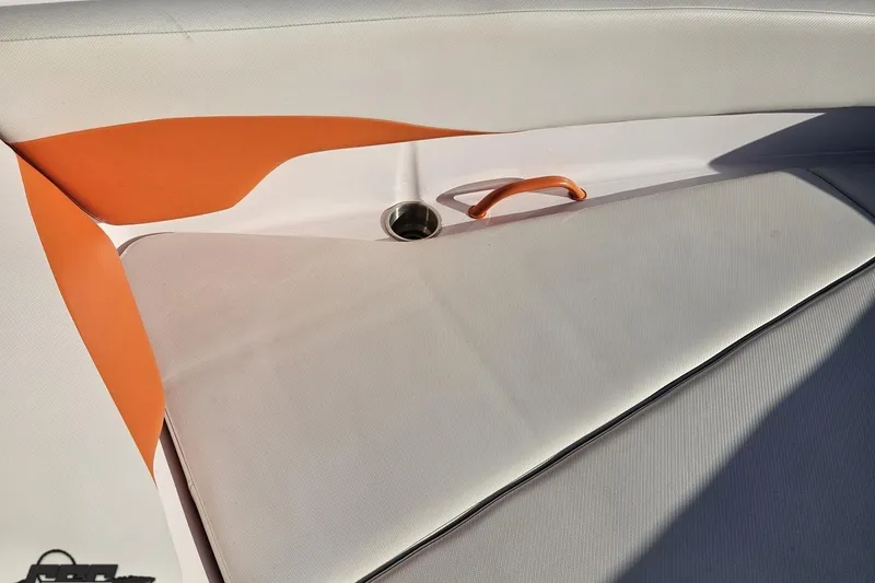 Slide: The Image of 2016 Baja 247 Islander boat interior with orange accents and cup holder. - 78
