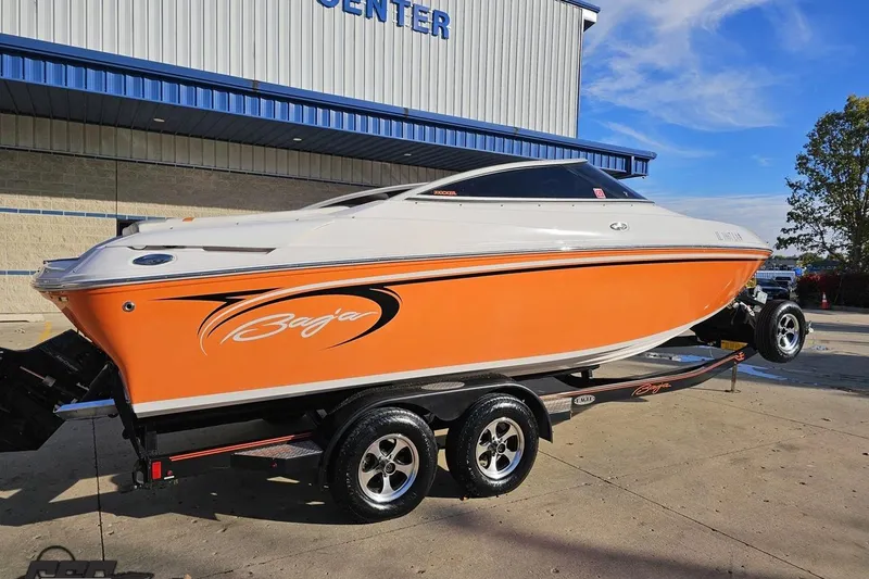 Slide: The Image of 2016 Baja 247 Islander boat with orange and white design on a trailer. - 8