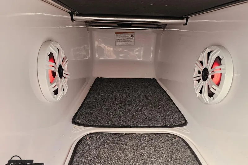 Slide: The Image of Interior of 2016 Baja 247 Islander boat with speakers and carpeted flooring. - 80