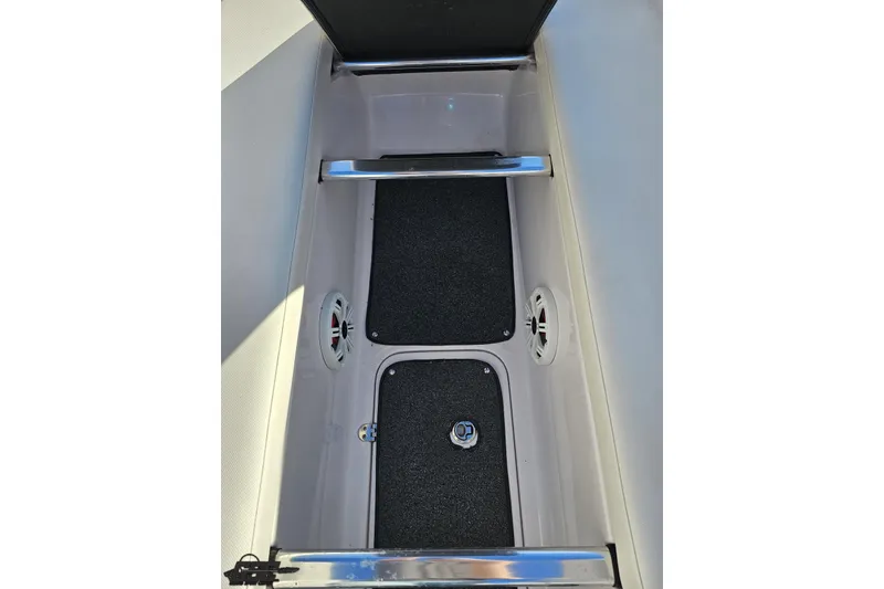 Slide: The Image of 2016 Baja 247 Islander boat storage compartment with speakers and carpeted interior. - 81