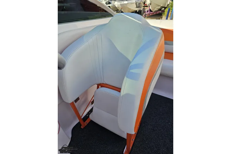 Slide: The Image of 2016 Baja 247 Islander boat seat with white and orange upholstery. - 87