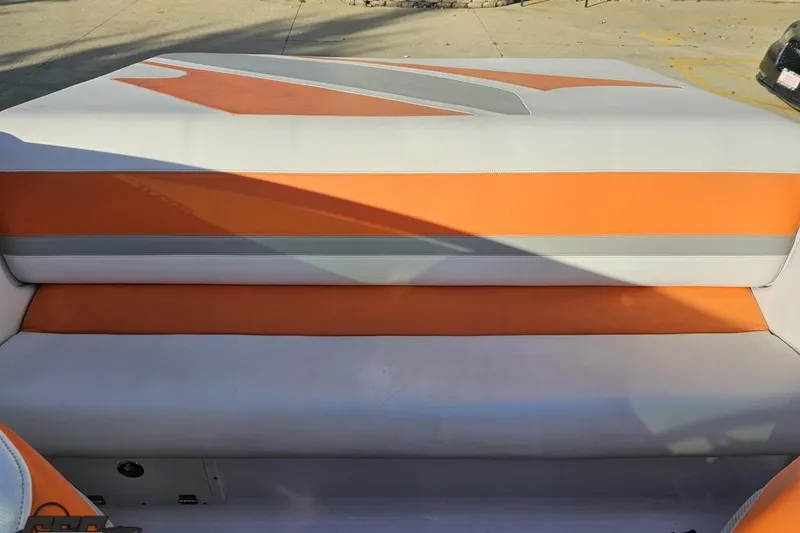 Slide: The Image of 2016 Baja 247 Islander boat seat with orange and gray upholstery. - 89