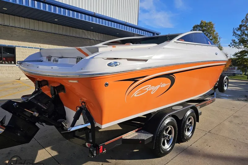 Slide: The Image of 2016 Baja 247 Islander boat with orange and white design on a trailer. - 9
