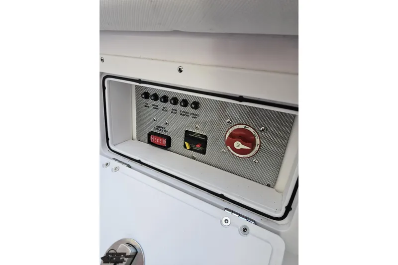 Slide: The Image of Control panel of a 2016 Baja 247 Islander boat, featuring switches and a red dial. - 92
