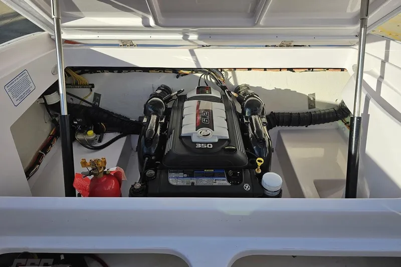 Slide: The Image of Engine compartment of a 2016 Baja 247 Islander boat, featuring a 350 horsepower engine. - 95