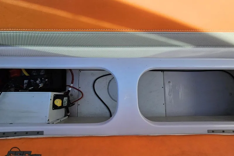 Slide: The Image of 2016 Baja 247 Islander boat storage compartment with battery and wiring. - 96