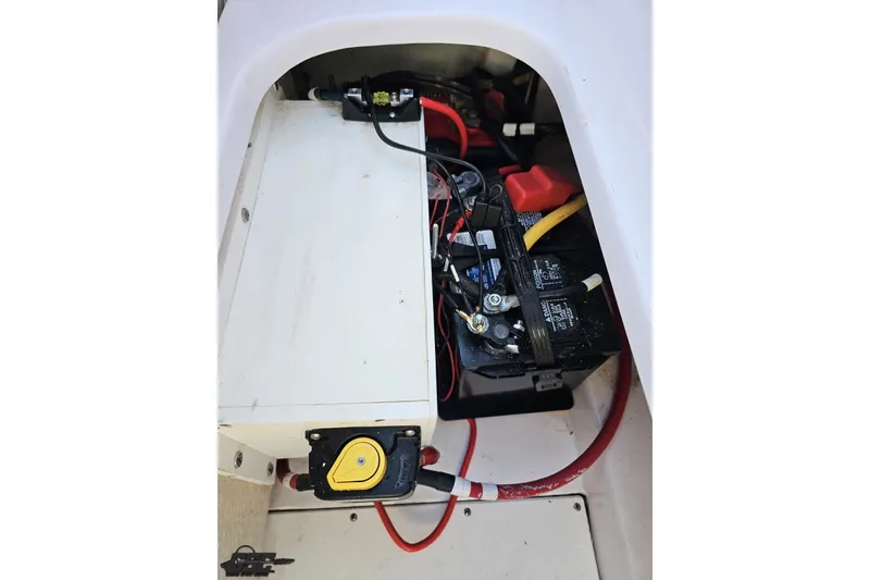 Slide: The Image of 2016 Baja 247 Islander boat battery compartment with wiring and connections. - 97