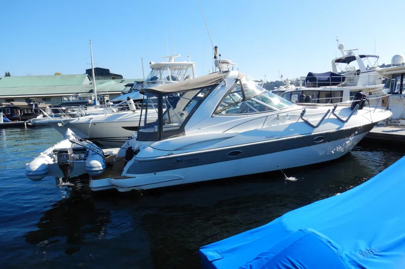 The Image of 2007 Cruisers 340 Express yacht docked in a marina, surrounded by other boats. - 0