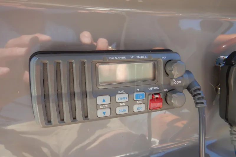 Slide: The Image of 2007 Cruisers 340 Express boat cockpit with steering wheel and control panel, docked at marina. - 17