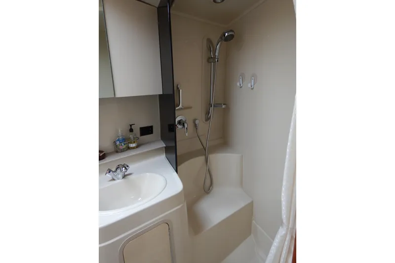 Slide: The Image of 2007 Cruisers 340 Express cabin interior with seating, table, and turtle-themed pillow. - 28