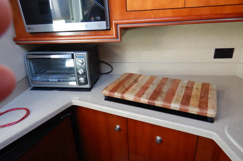 Slide: The Image of Cozy cabin interior of 2007 Cruisers 340 Express with bed and wooden cabinets. - 32