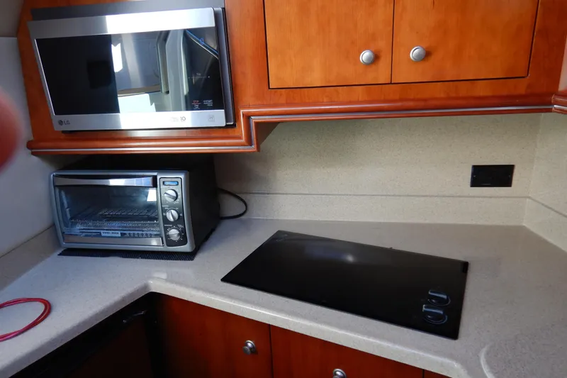 Slide: The Image of 2007 Cruisers 340 Express interior with TV and audio system on wooden paneling. - 33