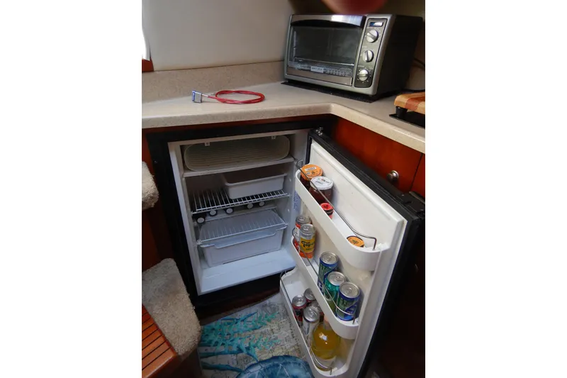 Slide: The Image of 2007 Cruisers 340 Express yacht interior with curved seating and wooden table. - 34