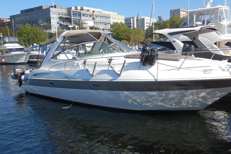 Slide: The Image of 2007 Cruisers 340 Express yacht docked in a marina, surrounded by other boats. - 1
