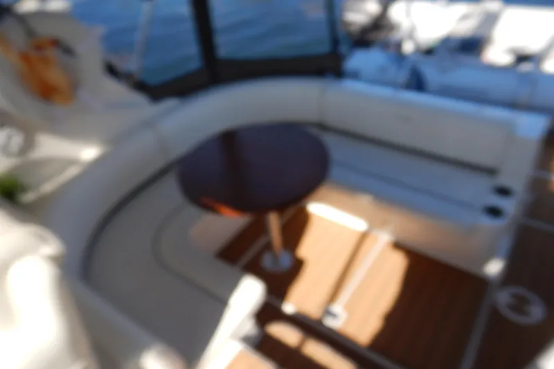 Slide: The Image of 2007 Cruisers 340 Express boat interior with a built-in refrigerator and teak flooring. - 10